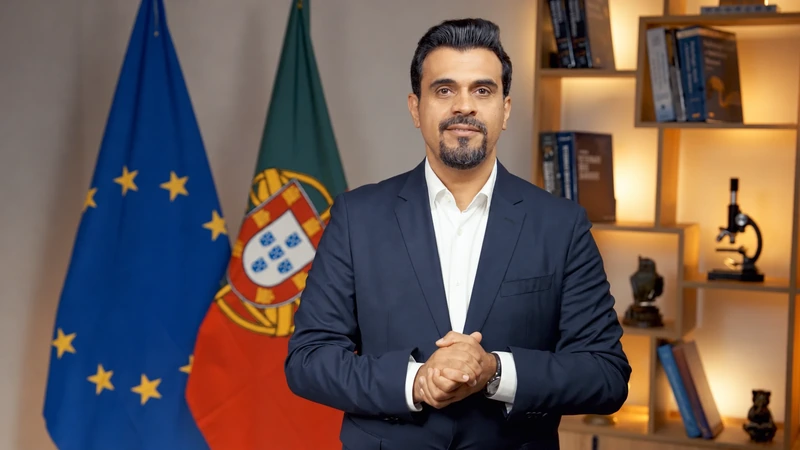 An educator standing in front of a European Union flag and a Portuguese flag